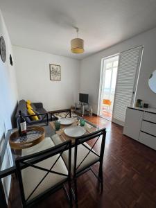 a living room with a table and chairs in it at América Apartment Holiday in Funchal