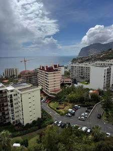an aerial view of a city with buildings and cars at América Apartment Holiday in Funchal