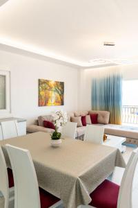 a living room with a table and a couch at Luxury Sea View Apartments in Sarandë
