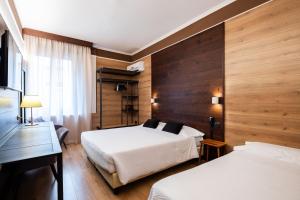 Postel nebo postele na pokoji v ubytování Hotel Italia