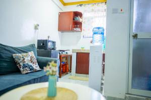 a living room with a couch and a vase on a table at Nayas Haven Studio2 in Mombasa Bamburi Mtambo Mwembeni with hot shower in Mombasa