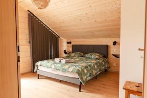 a bedroom with a bed and a wooden ceiling at Chalet Abies Alba in Gérardmer