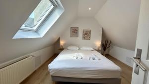 Ένα ή περισσότερα κρεβάτια σε δωμάτιο στο La Petite Maison – Charme & confort à deux pas de la mer