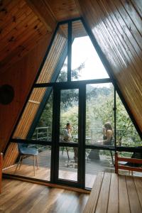 two people in a room with a large window at Vaio Resort in Keda in Keda
