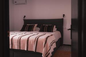 a bed with two pillows on it in a room at Villa Bellido in Alora +25 photos