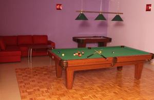 a living room with a pool table and a couch at Gościniec Europejski in Miedziana Góra