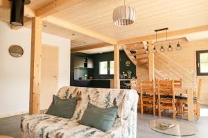 a living room with a couch and a table at Chalet Abies Alba in Gérardmer