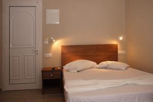 Postel nebo postele na pokoji v ubytování Kalouda Rooms