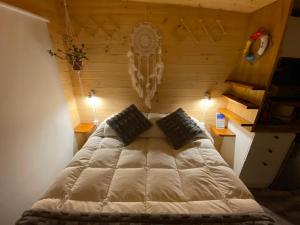 Postel nebo postele na pokoji v ubytování Hostal Kuyen