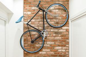 a bike is hanging on a brick wall at Elegante Bilocale in Zona Tortona in Milan
