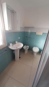 a bathroom with a sink and a toilet at Bilocale Su Lizzu de Erminia in La Caletta