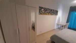 a bedroom with a closet and a bed and a cabinet at Bilocale Su Lizzu de Erminia in La Caletta