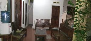 a living room with two chairs and a table at Homestay Rafa Borobudur in Sekatonan