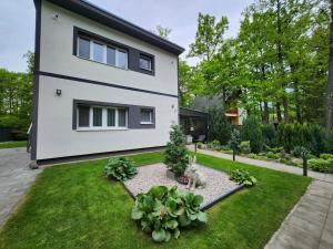 a house with a garden in front of it at Apartmán Kocka na prízemí in Šaštín