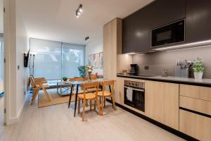 a kitchen with a table and chairs and a dining room at Luxury Living 2BR Ideal for Families in Santiago