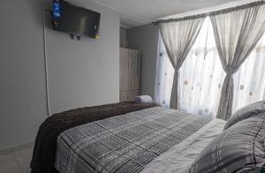 Postel nebo postele na pokoji v ubytování Habitación Privada en Kzona, Cerca al aeropuerto, Ideal para Escalas y Trámites