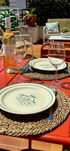 a table with two plates and wine glasses on it at Exclusive Top Floor - Love Suite in Nice