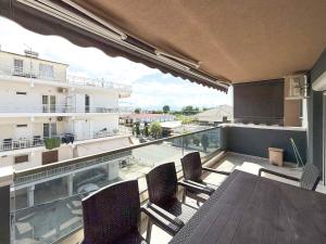 a balcony with a table and chairs on a building at Blue Star Suites by SDR in Paralia Katerinis