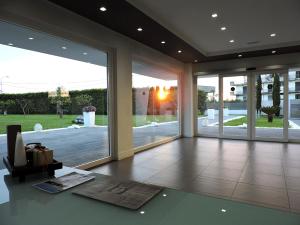 a living room with sliding glass doors and a table at Pietrabianca Exclusive Resort in Pomigliano dʼArco