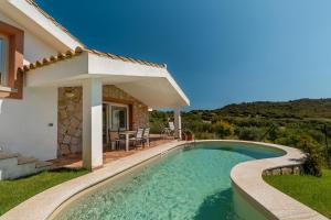 a villa with a swimming pool and a house at Villa Stefanina - Vista mare e piscina privata vicina alla spiaggia di Cala Sinzias in Castiadas