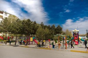 a group of children playing in a playground at SelfHouse in Masazır