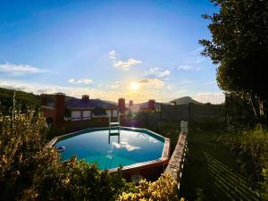 a swimming pool in the yard of a house at Casa Mirador del Pas - Monabri in Boó de Piélagos