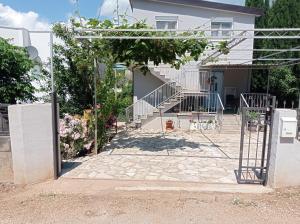 a house with a gate and stairs in front of it at Olga 112 in Bar +5 photos