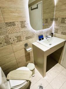 a bathroom with a sink and a toilet and a mirror at Grecian Sea in Limenaria +132 photos