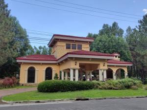 a yellow house with a red roof at Mi Casa Nova in Bacolod