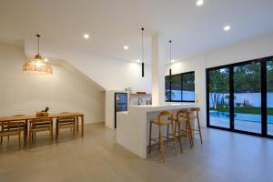a kitchen and dining room with a table and chairs at Balear Villa in Kuta Lombok