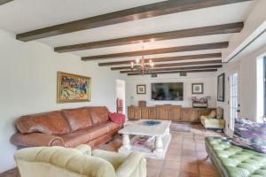 a living room with a couch and a table at 2 Mi to Dtwn Spacious Angleton Home with Courtyard! in Angleton