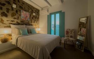 a bedroom with a bed and a large window at 65 Stairs Τo Ηeaven Private Pool in Áno Meriá +49 photos
