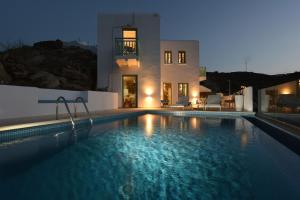 a villa with a swimming pool at night at 65 Stairs Τo Ηeaven Private Pool in Áno Meriá