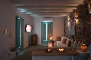 a living room with a couch and a table at 65 Stairs Τo Ηeaven Private Pool in Áno Meriá