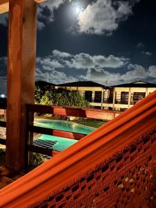 a view from the top of a bench with the moon at Ondas do mar Taiba Residence in Taíba
