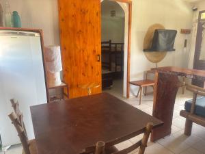 a room with a wooden table and a mirror at Ondas do mar Taiba Residence in Taíba