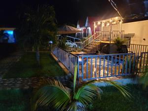 a house with a blue railing and stairs at night at Villa Victoria Campestre in Rivera