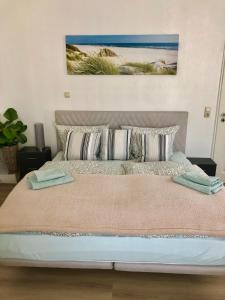 a bedroom with a large bed with pillows at Nordsee Pension in Garding