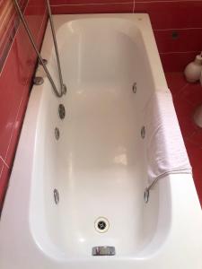 a white bath tub with a roll of toilet paper in it at Apartmani Centar in Petrovac na Moru +95 photos
