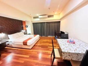 Postel nebo postele na pokoji v ubytování SUNVAY RESORT SUITe + 17 fotografií