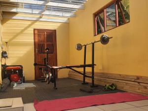 a room with a gym with a treadmill at Tranquil Coastal Home with Pool Family-Friendly Stay in Uvongo Beach