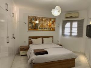 a bedroom with two beds and a painting on the wall at Regency Towers Apartments in Hurghada +73 photos