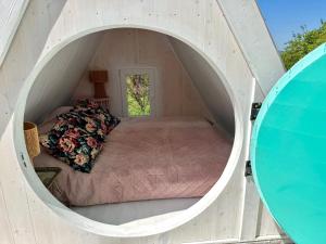 a small bedroom with a bed in a tunnel at Lavender Eco lodge át lake Balaton in Kisapáti