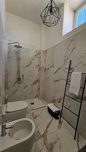 a bathroom with a sink and a toilet and a mirror at Flamingo B&B in Pompei +77 photos