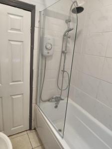a shower with a glass door in a bathroom at Double-Bedroom in the Heart of Harpurhey Manchester A3 Perfect for Short Stays in Manchester