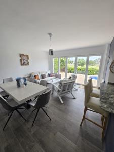 a living room with a couch and a table and chairs at Mar Menor Golf Resort , La maison bleue, villa piscine privée in Los Martínez
