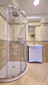 a large bathroom with a shower and a sink at Villa Vittoria in Cefalù