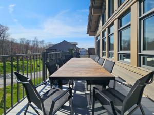 a wooden table and chairs on a balcony at Tremblant Prestige - Verbier 12-203 in Mont-Tremblant