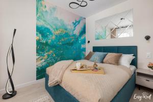 a bedroom with a bed with a tray on it at De-Lux M - Easy - Rent Apartments in Niechorze