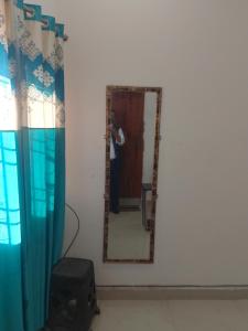 a man taking a picture of himself in a mirror at Ashiyana Upvan in Lucknow